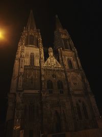 Low angle view of illuminated building against sky at night