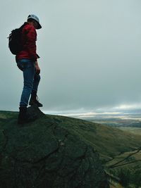 Man standing on mountain against sky