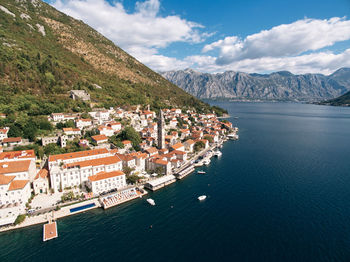 High angle view of townscape by sea against sky