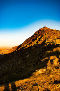 Scenic view of mountains against clear blue sky