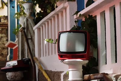 Close-up of old television in balcony