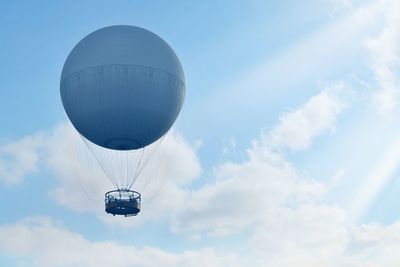 Low angle view of hot air balloon against blue sky