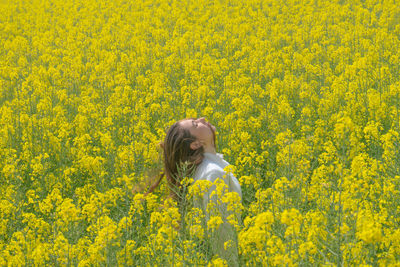 Close-up of yellow flowering plants on field