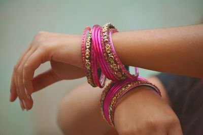 Midsection of woman wearing bangles