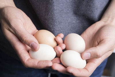 Close-up of man holding eggs