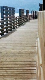 Boardwalk at beach against sky