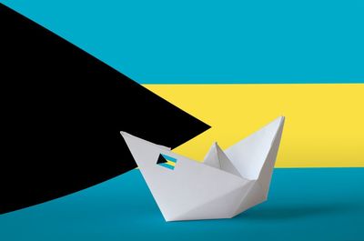 Close-up of paper flag against blue background