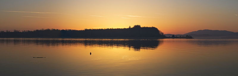 Scenic view of lake against sky during sunset