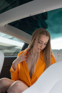 Young woman sitting in car