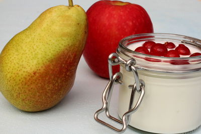 Close-up of apples in glass jar on table