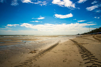 Scenic view of beach against blue sky