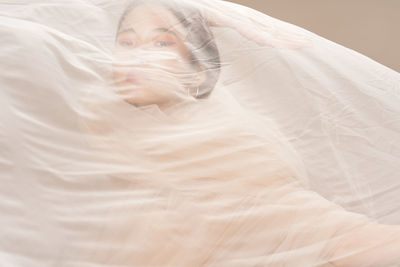 Portrait of woman seen through netting