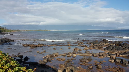 View of calm sea against cloudy sky