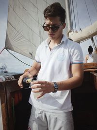 Young man wearing sunglasses standing outdoors