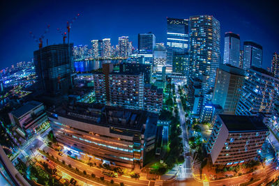 High angle view of illuminated buildings in city at night