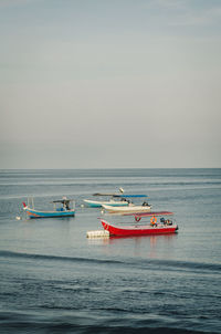 Fishing boat in sea against sky