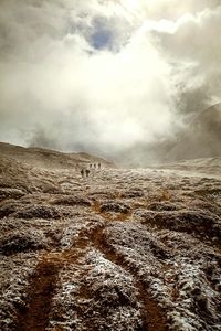 Scenic view of mountains against cloudy sky