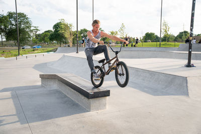 Side view of man riding bicycle