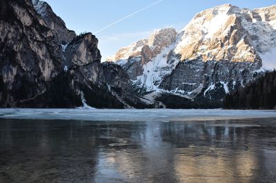 Scenic of frozen lake with dolomites against sky