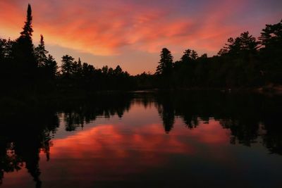 Scenic view of lake against orange sky