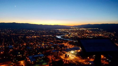 High angle view of illuminated buildings against sky at night