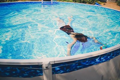 High angle view of girl swimming in pool