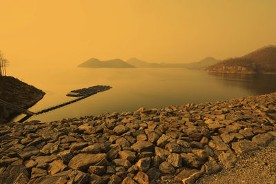 Scenic view of sea against clear sky during sunset