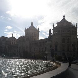 Buildings against cloudy sky