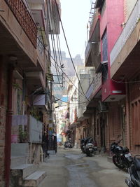 Street amidst buildings in city against sky