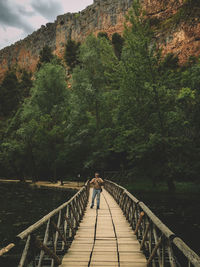 Footbridge leading towards trees