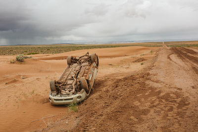 Flipped upside car off the road on a desert dirt backroad in utah