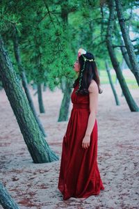 Young woman standing on footpath in forest