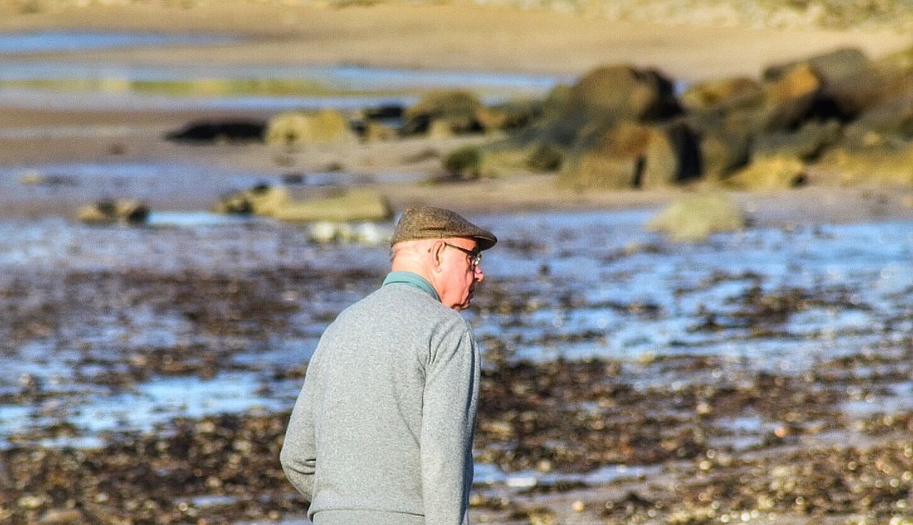 SIDE VIEW OF MAN STANDING ON WATER