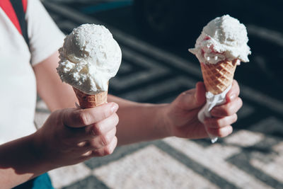 Cropped hand holding ice cream cone