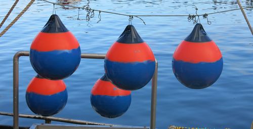 Multi color buoy hanging above water