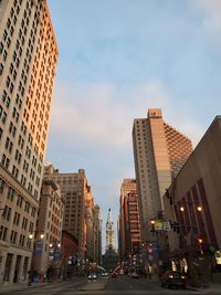 View of city street and buildings against sky