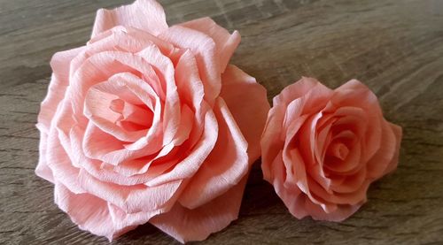 Close-up of pink rose on table