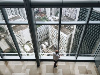High angle view man standing by window in building