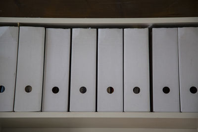 Files arranged in shelf at office