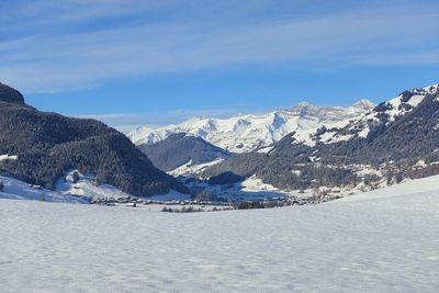 Scenic view of snowcapped mountains against blue sky gstaad luxury swiss alps alpine resort 