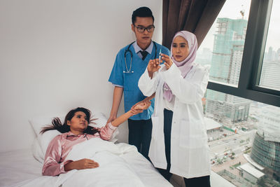 Young couple standing on bed