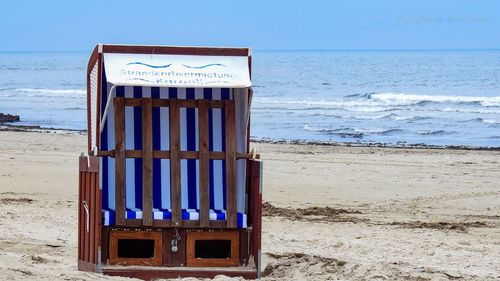 Built structure on beach against sky