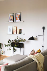 Living room with gray sofa and various pictures and decorative elements.