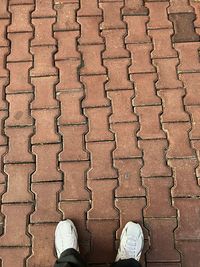 Low section of man standing on footpath