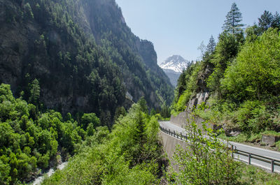 Panoramic view of road amidst trees and mountains against sky