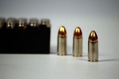 Close-up of bullets over white background