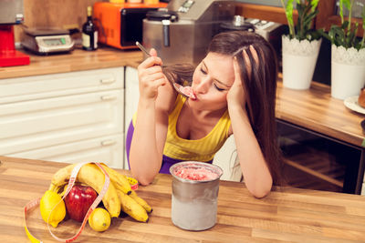 Midsection of woman preparing food at home