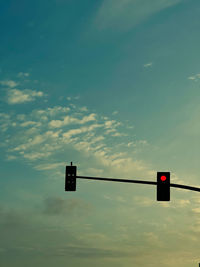 Low angle view of road sign against sky