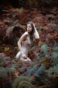 Woman between fern