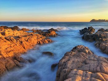 Scenic view of sea against sky during sunset